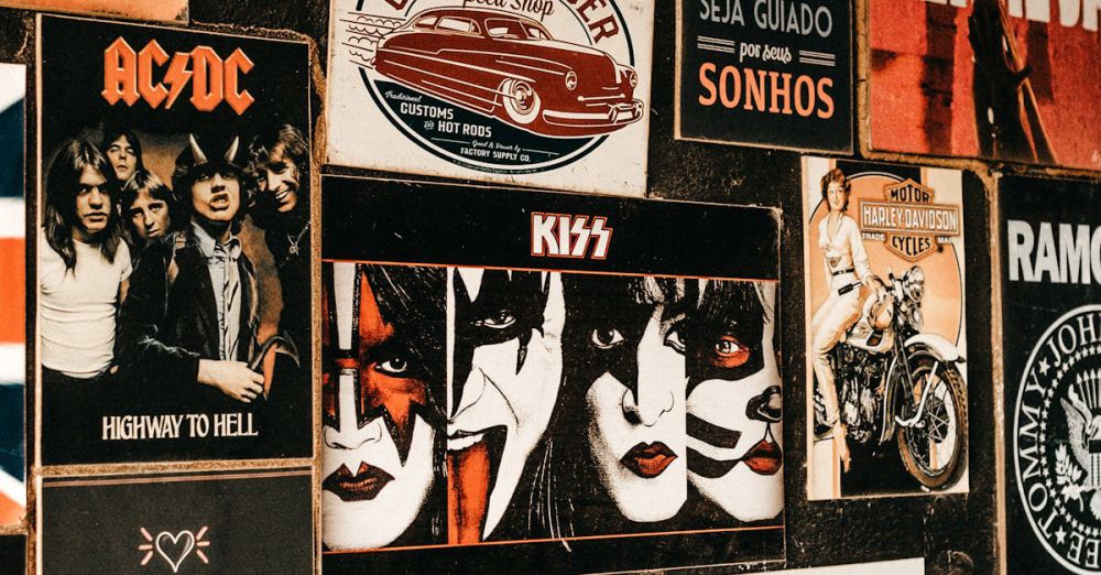 Posters - A collage of iconic rock band posters and vintage advertisements on a textured wall.