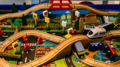 Model Trains - Vibrant and detailed wooden toy train set with roads, bridges, and signs for imaginative play.