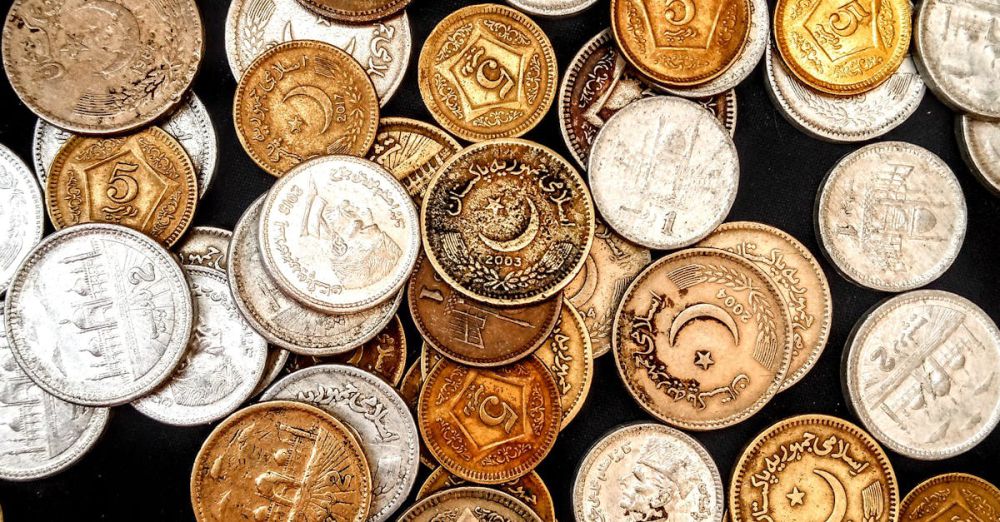 Rare Coins - A diverse collection of vintage and collectible coins displayed on a surface, showcasing their varied designs and metallic textures.