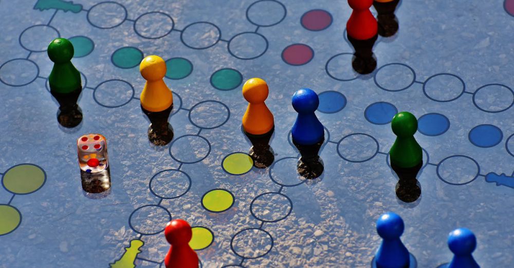 Board Games - Close-up of a colorful board game with pawns and a dice, perfect for family fun.