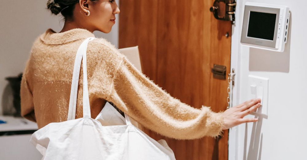 Thermostats - Woman adjusting thermostat while holding shopping bag, showcasing a modern home lifestyle.