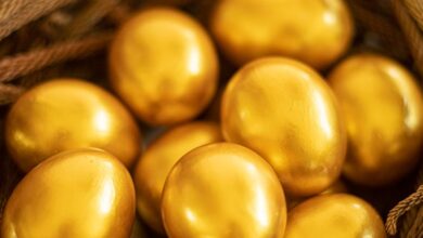 Holiday Decor - Close-up of golden eggs elegantly arranged in a woven basket, symbolizing luxury and Easter themes.