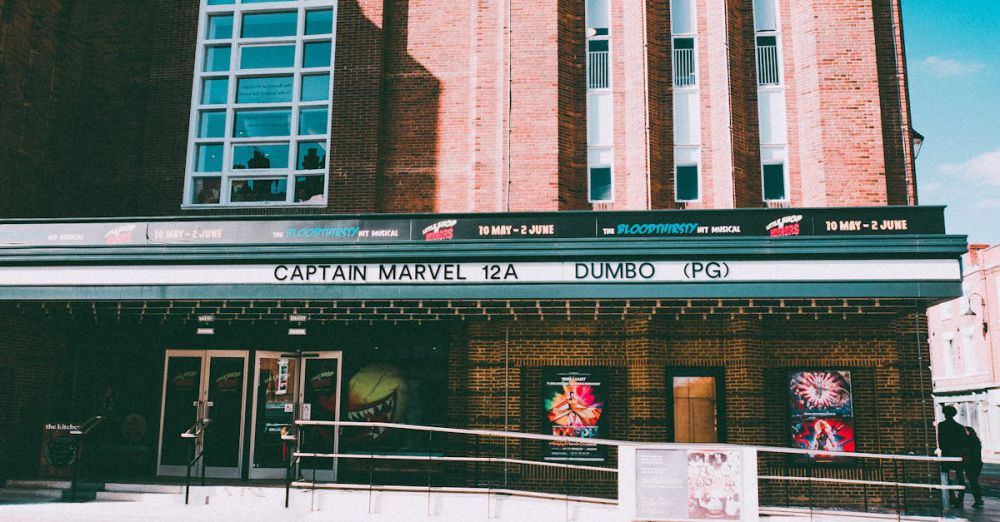 Film Posters - Historic cinema facade displaying movie posters of Captain Marvel in Chester, UK.