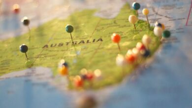 Locations - Close-up of a map of Australia with colorful pins marking various cities and destinations.