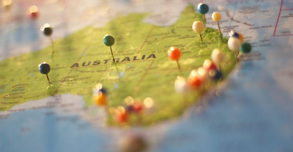 Locations - Close-up of a map of Australia with colorful pins marking various cities and destinations.