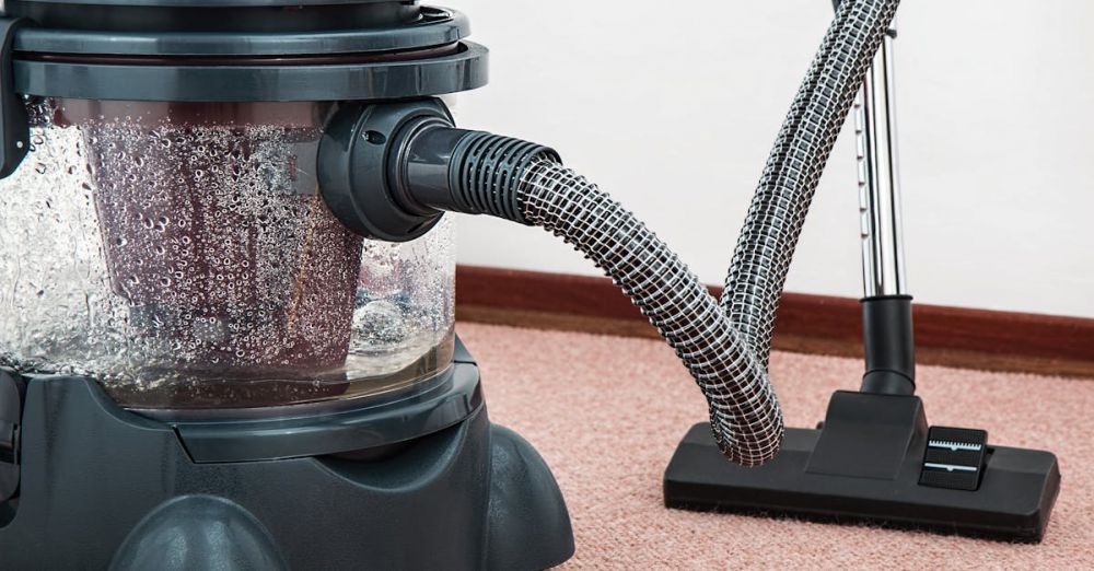 Vacuum - Close-up of a modern vacuum cleaner with water filtration on carpet floor indoors.