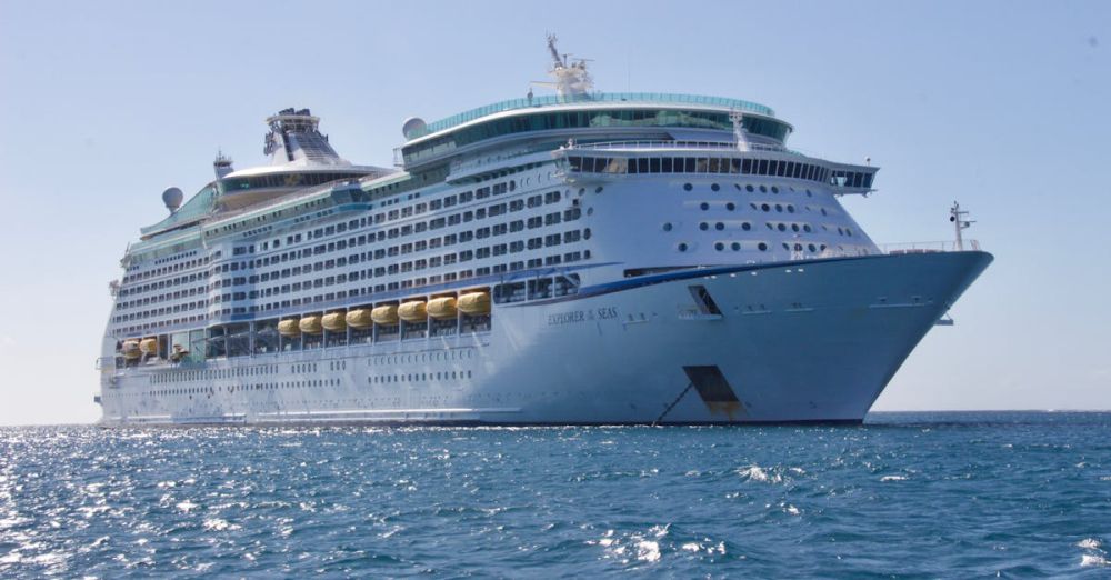 Cruise Ship - A luxurious cruise ship sailing on the ocean under a clear blue sky, ideal for travel and leisure.