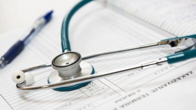 Health - A stethoscope and pen resting on a medical report in a healthcare setting.