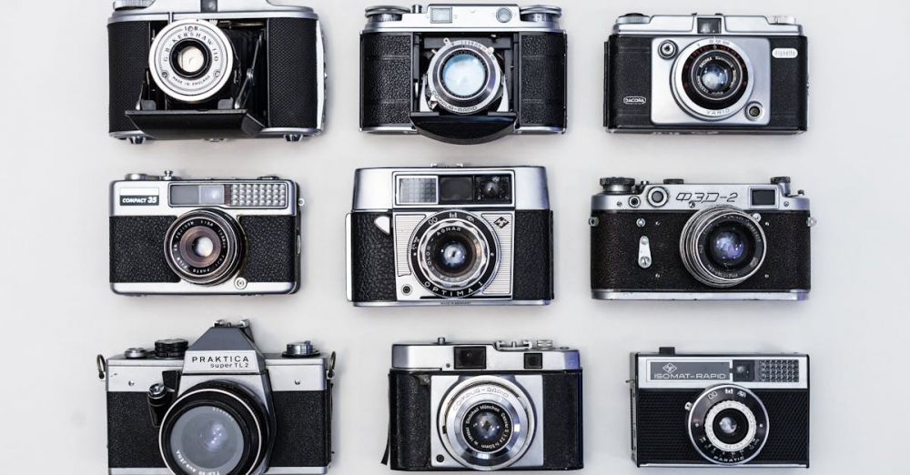 Cameras - A flat lay of various vintage cameras showcasing classic photographic equipment.