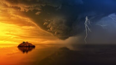 Weather - A stunning display of a stormy sunset with lightning striking over a solitary island.