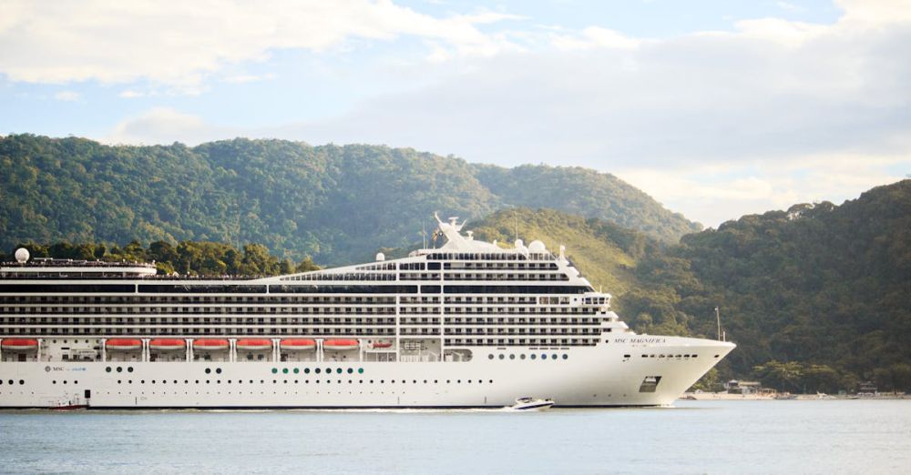 Cruise - A majestic cruise ship sails through tranquil waters with lush hills in the background, perfect for travel enthusiasts.