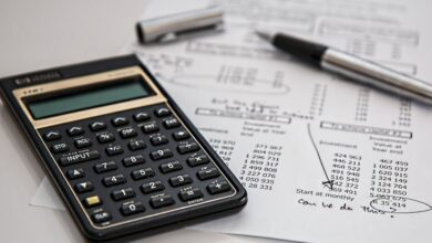 Budget - Close-up of financial documents with calculator and pen, ideal for business management themes.