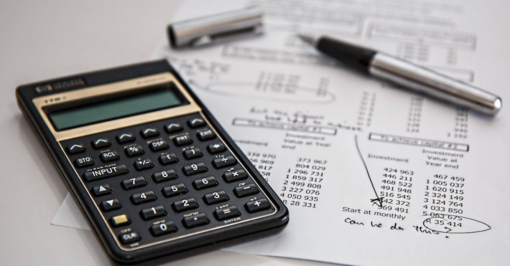 Budget - Close-up of financial documents with calculator and pen, ideal for business management themes.