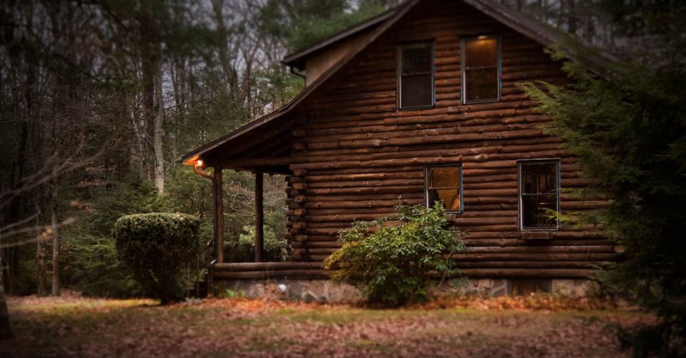 Cabin - A cozy log cabin surrounded by autumn trees, showcasing warm lighting and tranquil nature.