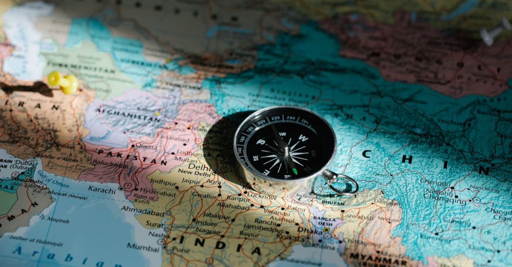 Other Countries - Close-up image of compass on a world map highlighting travel direction and exploration.