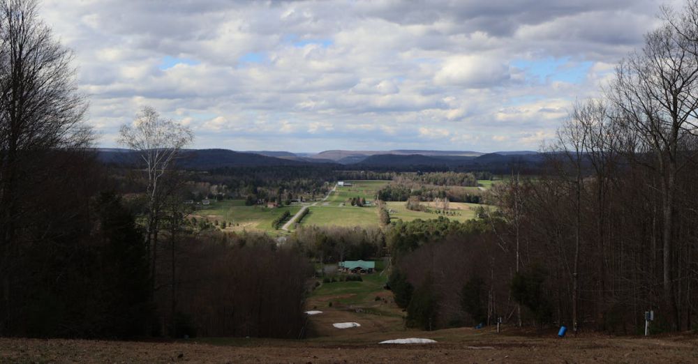 Ski Resorts - Picturesque landscape view in Morris, PA showcasing expansive fields under a cloudy sky.