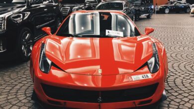 Expensive - Red Ferrari sports car showcased at Dubai Mall, UAE, symbolizing luxury and elegance.