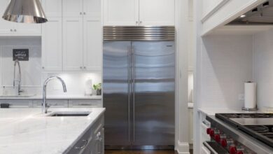 Fridge - A sleek modern kitchen featuring stainless steel appliances and marble countertops.