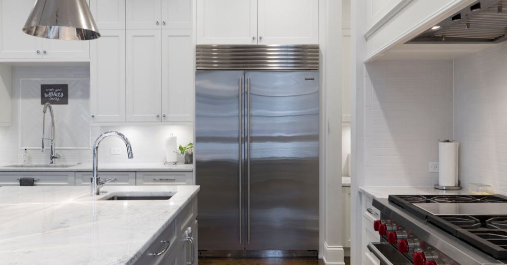 Fridge - A sleek modern kitchen featuring stainless steel appliances and marble countertops.