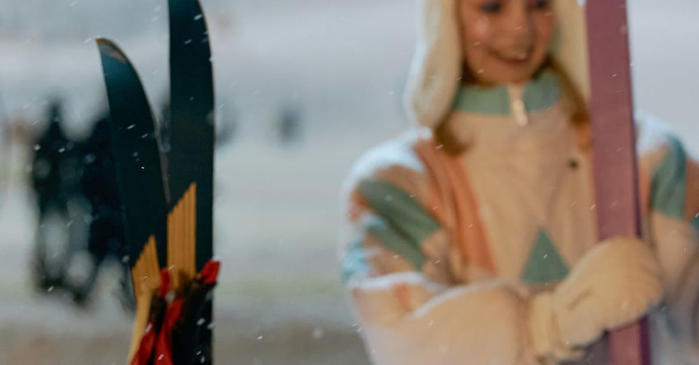 Après-Ski - A person enjoys a warm bonfire near ski equipment during a snowy winter evening in a ski resort.