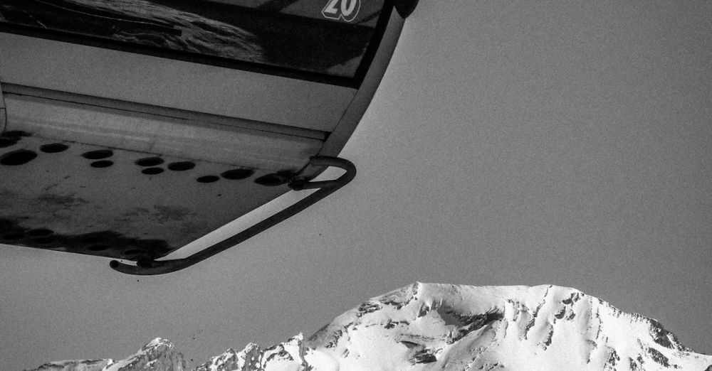 Lift Pass - Snowy mountain landscape with Beauregard gondola lift in La Clusaz, France.