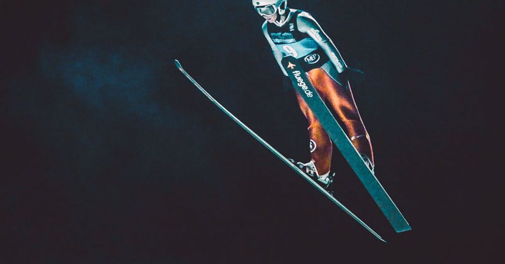 Skiing Skills - Dramatic night-time shot of a skier performing a ski jump mid-air, showcasing athleticism.