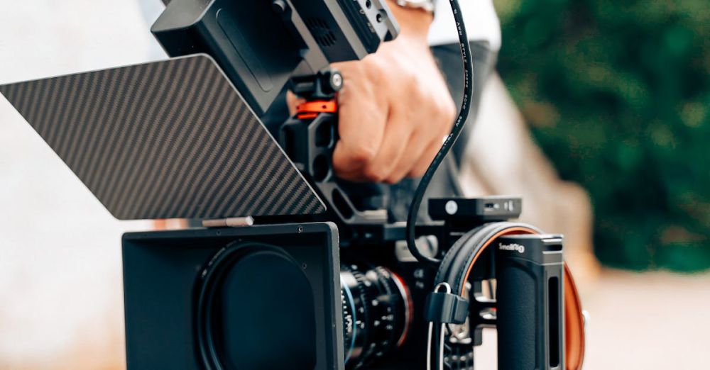 Advanced Skiers - A man holding a camera with a small camera attached