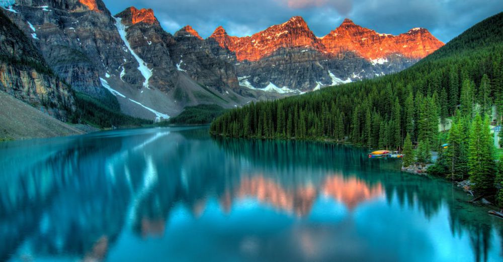 National Parks - Capture the serene beauty of Moraine Lake with sunrise reflections in Banff National Park.