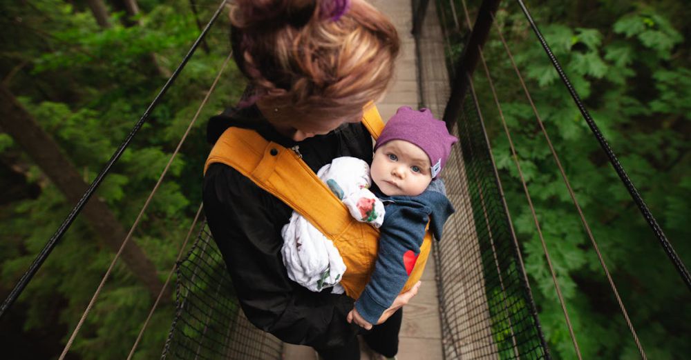 Family Trails - A woman carries her baby over a forest suspension bridge, highlighting maternal care.