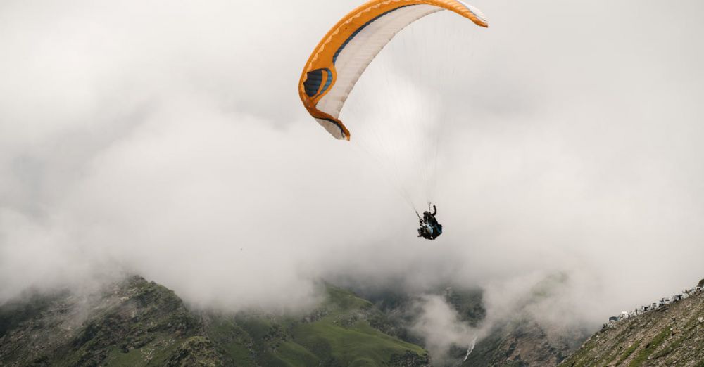 Free Trails - Experience the thrill of paragliding amidst lush mountain valleys and clouds.