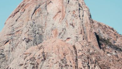 Photogenic Trails - Majestic rocky mountain peak standing tall under a clear blue sky, perfect for travel and nature enthusiasts.