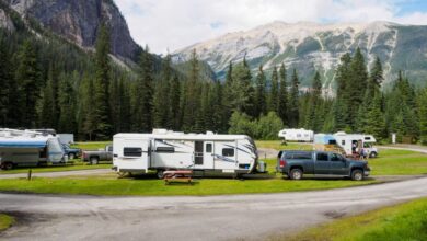 RVs - A beautiful campsite featuring RVs amidst lush forests and towering mountains for a peaceful getaway.