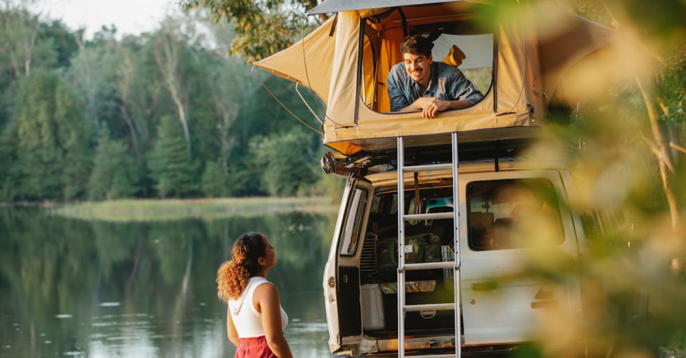 Lakeside Camping - A couple enjoying a summer camping trip by a scenic lakeside in a rooftop tent.