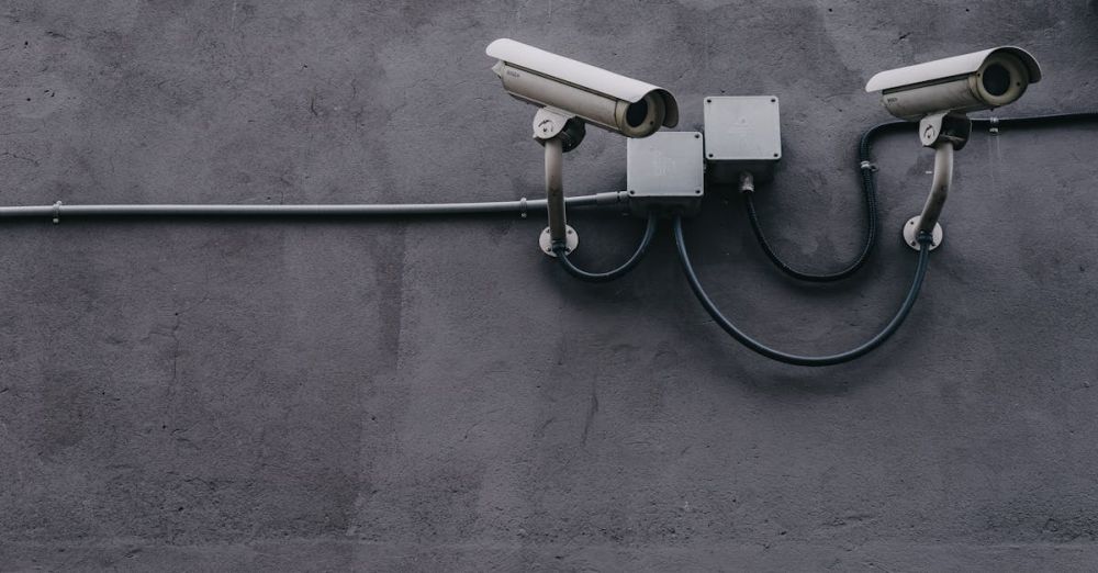 Safety - Two surveillance cameras mounted on a concrete wall, highlighting security technology.