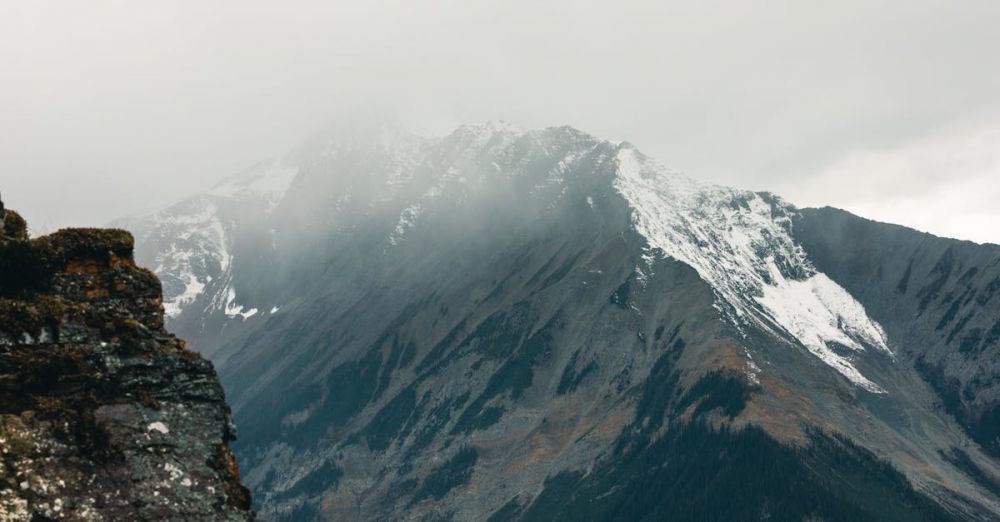 Remote Parks - Captured in Field, BC, a majestic mountain partly shrouded in mist creates a dramatic scene.