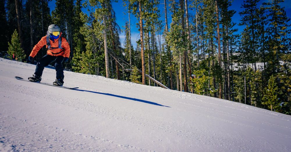 Adventure Sports - A person riding a snowboard down a snowy slope