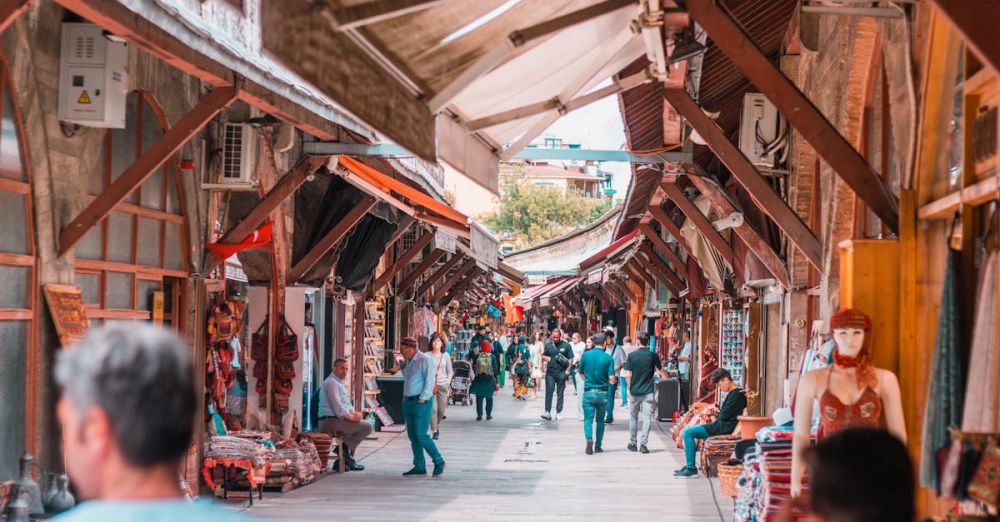 Popular Tours - Explore the bustling atmosphere of a Turkish street market in Istanbul with people and shops.