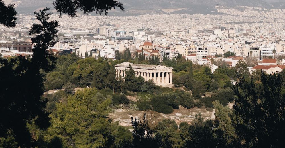 History Tours - Panoramic view of Athens cityscape with ancient temple surrounded by greenery.