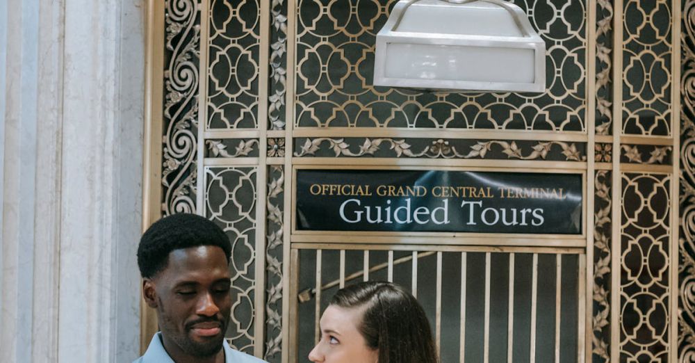 Self-Guided Tours - Happy couple standing outside a guided tour office at Grand Central Terminal, sharing a moment.