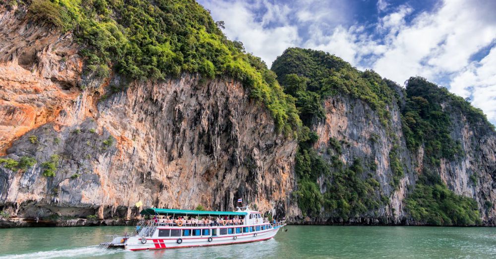 Scenic Tours - A boat cruise offers breathtaking views of lush cliffs under a bright blue sky.