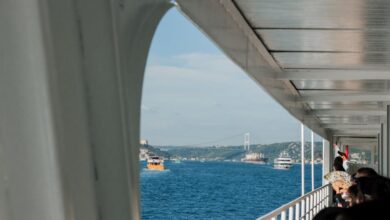 Choosing Tour - Passengers enjoy a ferry ride with views of the Bosphorus Bridge in Istanbul.