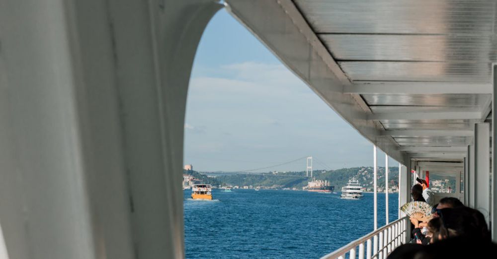 Choosing Tour - Passengers enjoy a ferry ride with views of the Bosphorus Bridge in Istanbul.