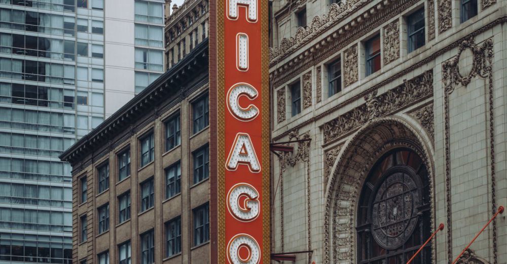 Architecture Tours - Photo of the famous Chicago Theater with a vibrant marquee on a bustling urban street.