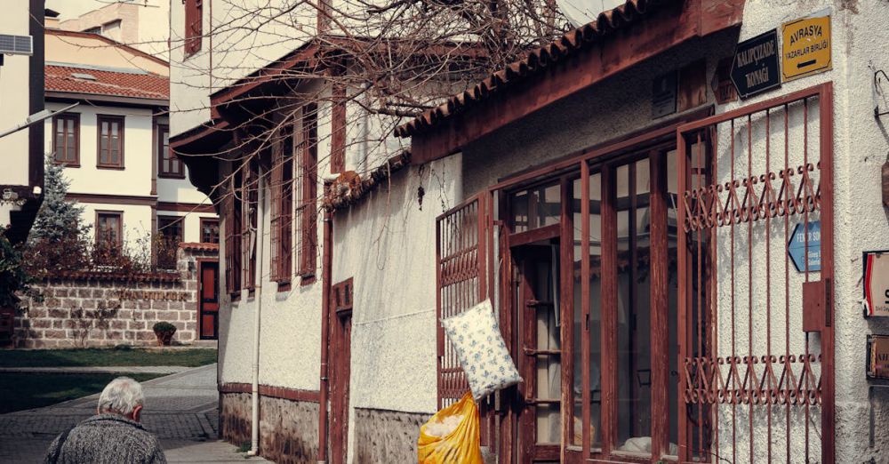 Winter Tours - A man walking down a street with a yellow umbrella