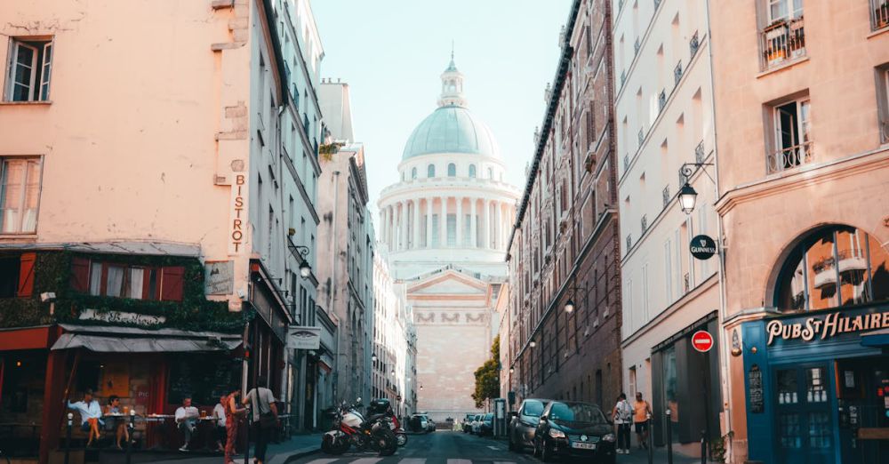 Tour Photos - Charming Parisian street leading to the iconic Pantheon dome, capturing urban life and architecture.