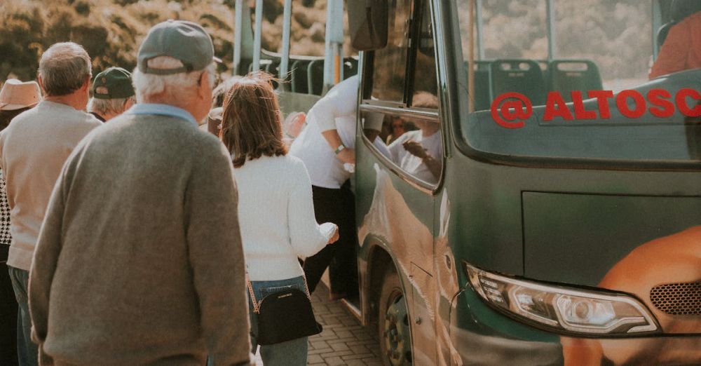 Group Tours - Group of people boarding a bus surrounded by nature, showcasing travel and transportation.