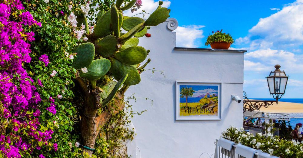 Garden - Charming Mediterranean balcony adorned with vibrant bougainvillea, overlooking sea.