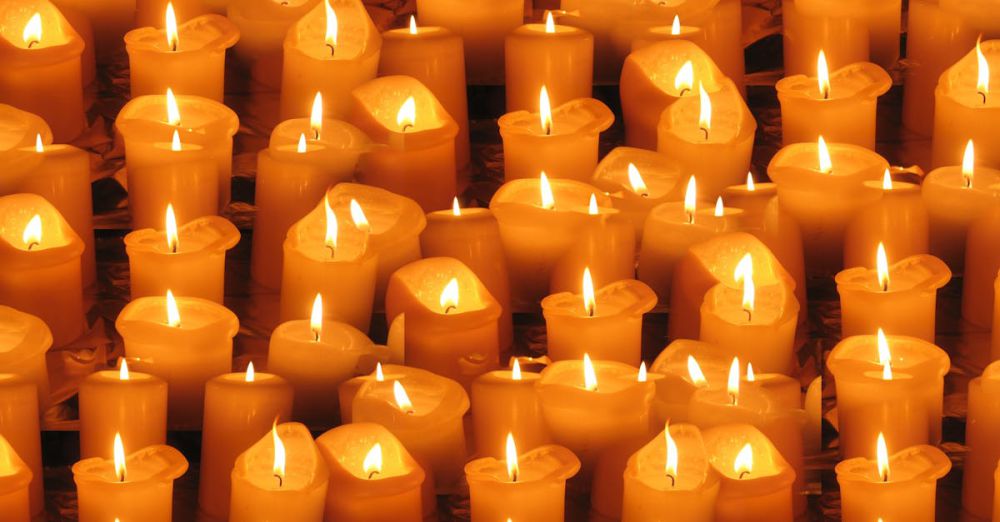 Festival Safety - A warm and serene display of numerous burning candles arranged closely together.