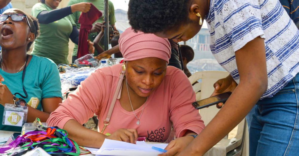 Festival Volunteering - Group of volunteers working on registration at a community event outdoors.