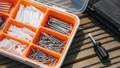 Kits - From above of container with assorted instruments placed on wooden surface near screwdriver and black case on street in sunlight